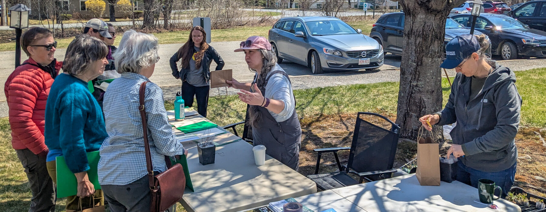 Desiree Narango and Amber Jones explain the Adopt-a-Plant project to volunteers